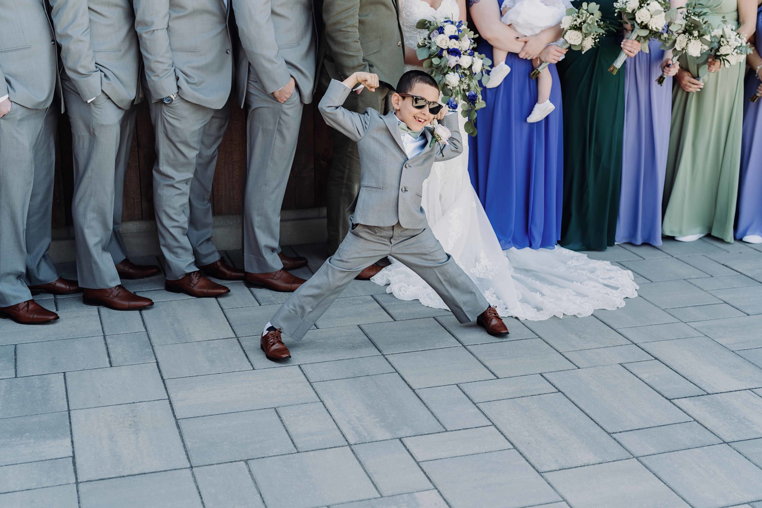 Ring bearer flexing with wedding party at Wrights Mill Farm