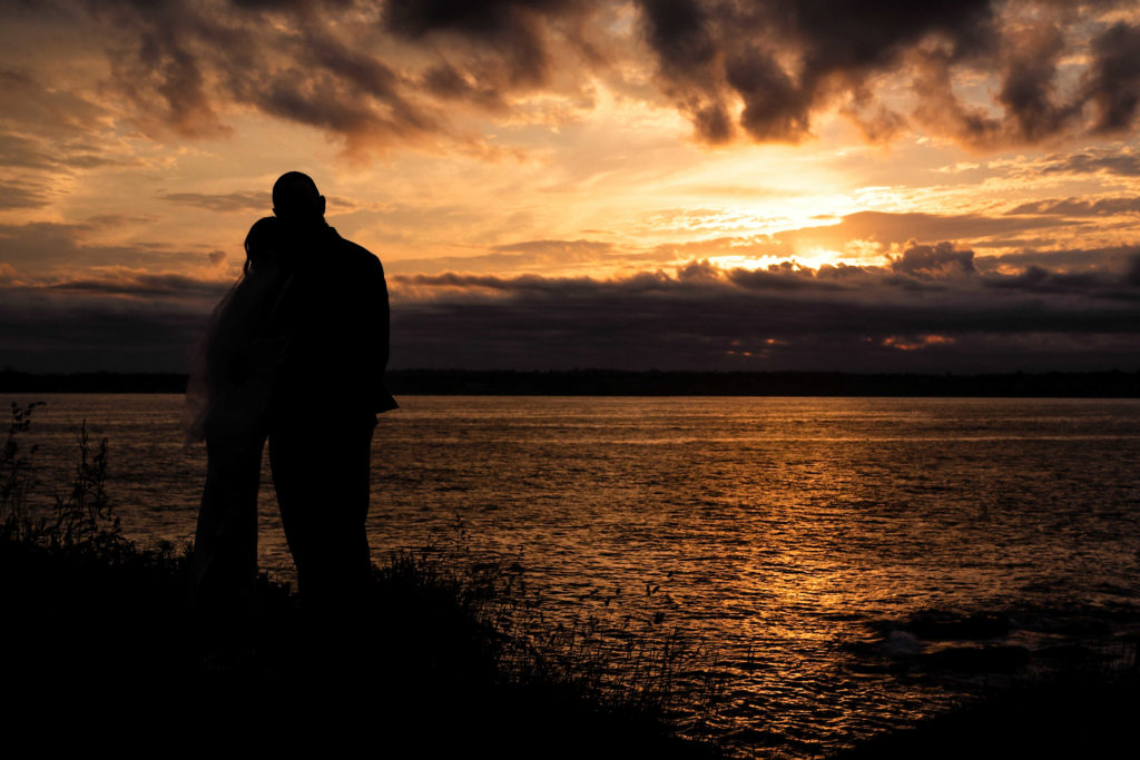 Couple enjoying a sunset over the ocean