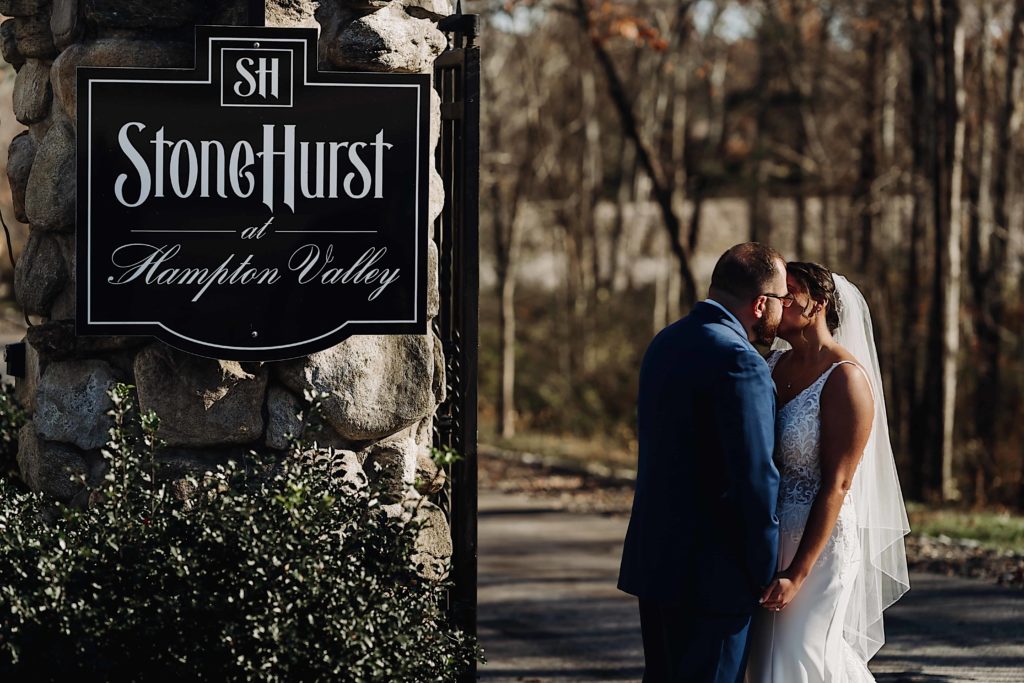 Bride and Groom share a first look kiss at the gat of Stonehurst At Hampton Valley Connecticut wedding venue