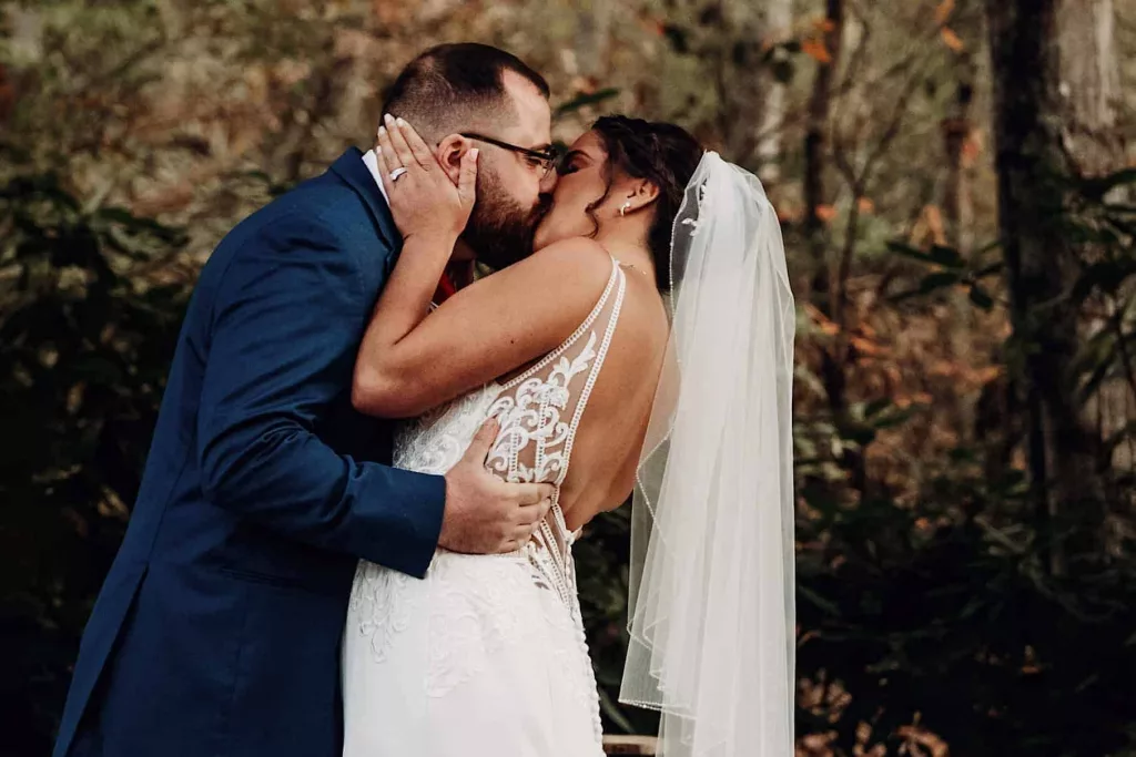 Husband and wife first kiss at Stonehurst at Hampton Valley in Hampton Connecticut