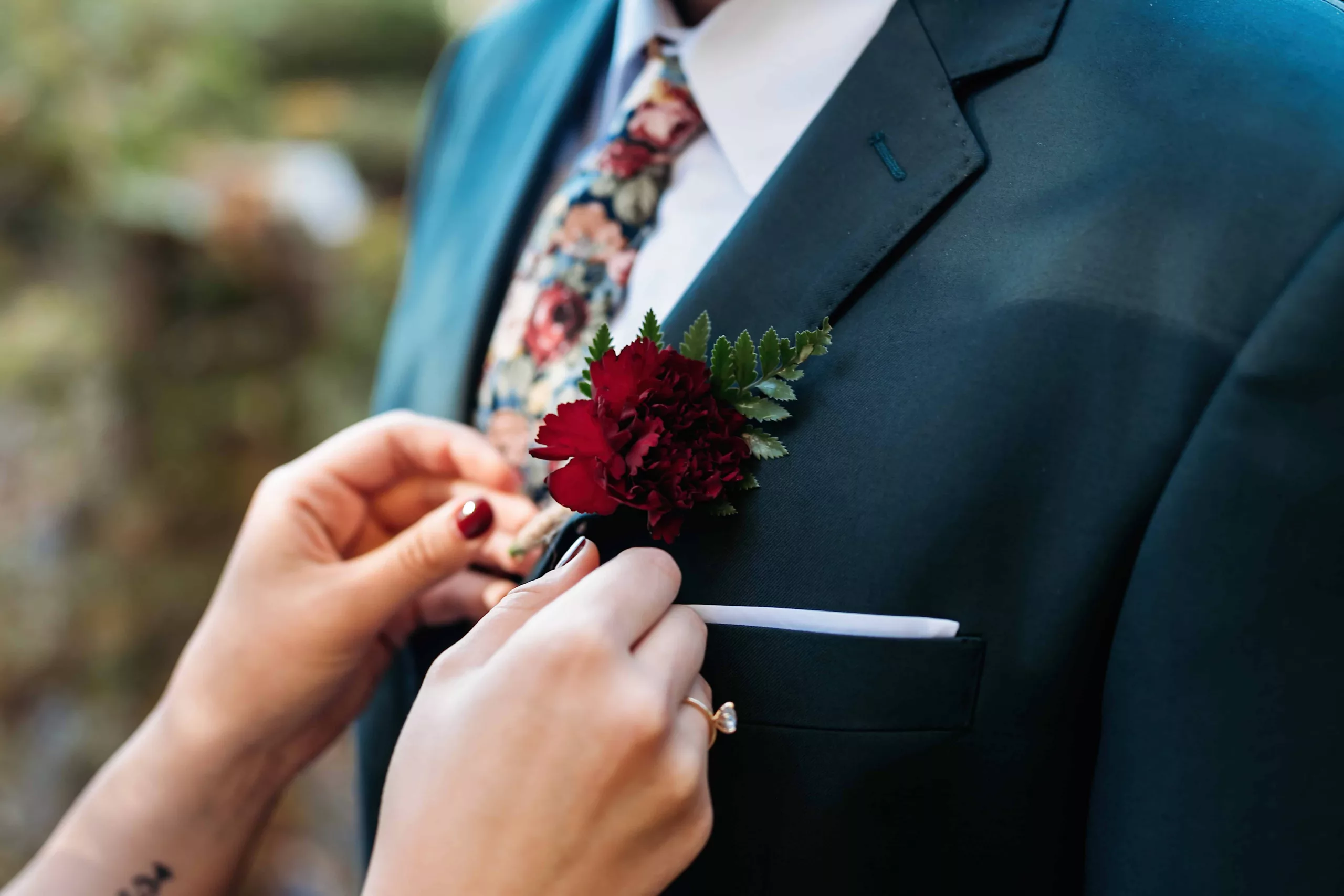 Bride pinning a Boutonniere on her husband.