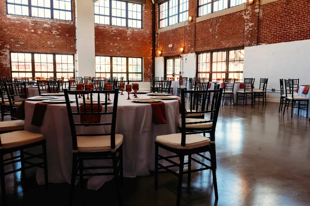 wide interior shot of the Station 97 industrial wedding venue with table and chairs set up