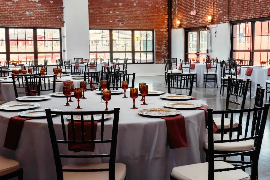 wide interior shot of the Station 97 industrial wedding venue with table and chairs set up