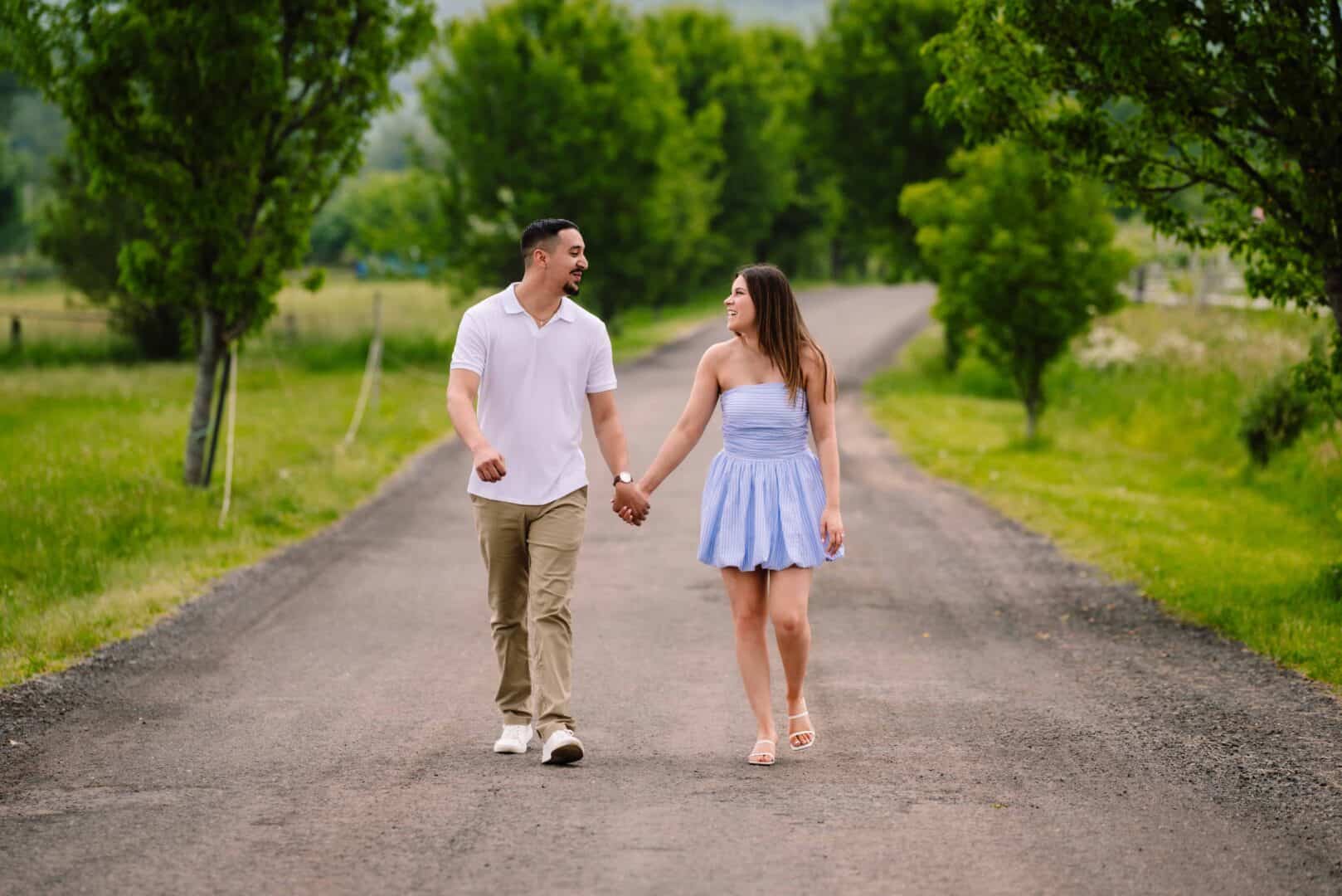Couple walking on a country road at a vineyard