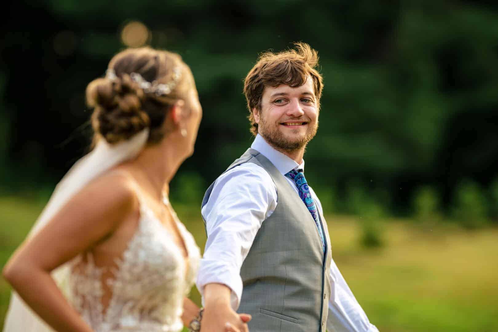 Bride and groom laughing together during their wedding portraits, photographed by Ladman Studios, a Connecticut wedding photographer capturing fun, natural moments.