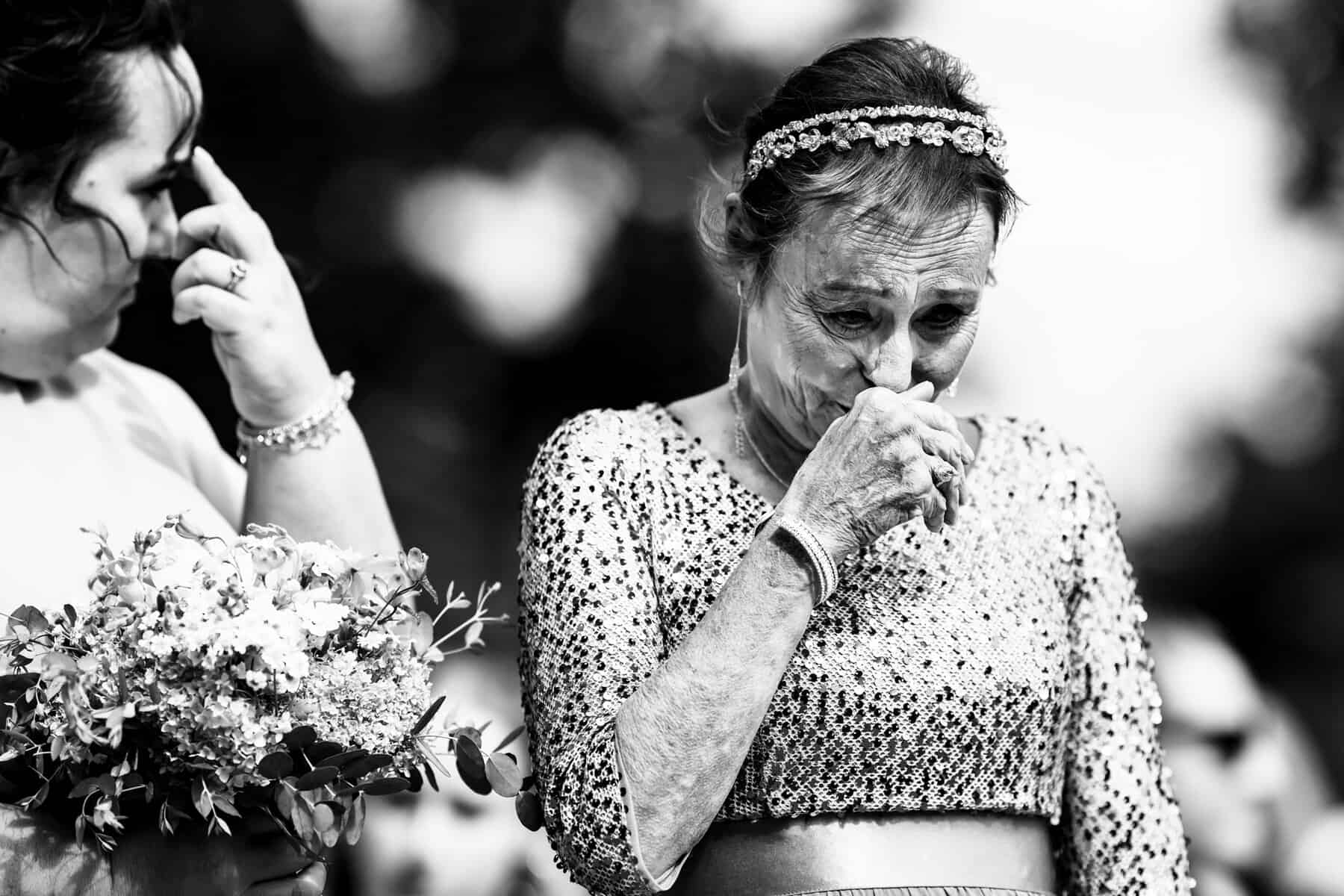 Documentary wedding photographer capturing emotional mother during ceremony in Connecticut
